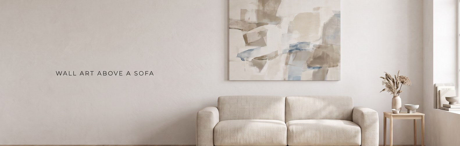 What size wall art goes above a sofa: a large canvas hung above a low neutral sofa