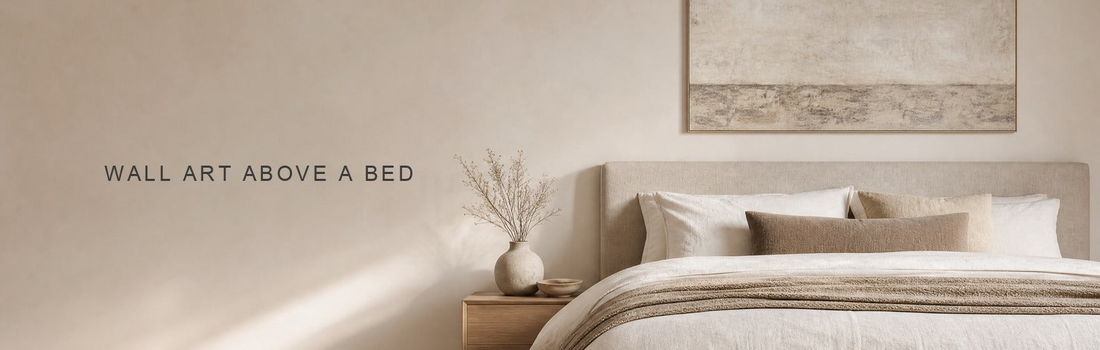 Wall art above bed: a wide canvas centerd above an upholstered headboard