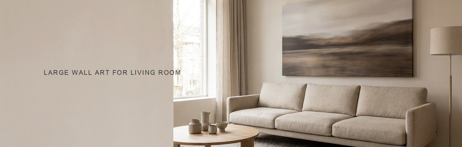 Large wall art for living room: an oversized canvas above a three seat sofa