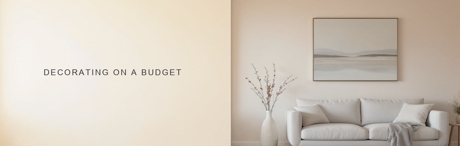 Decorating on a budget: one canvas print, a plain sofa and a jug of cut branches