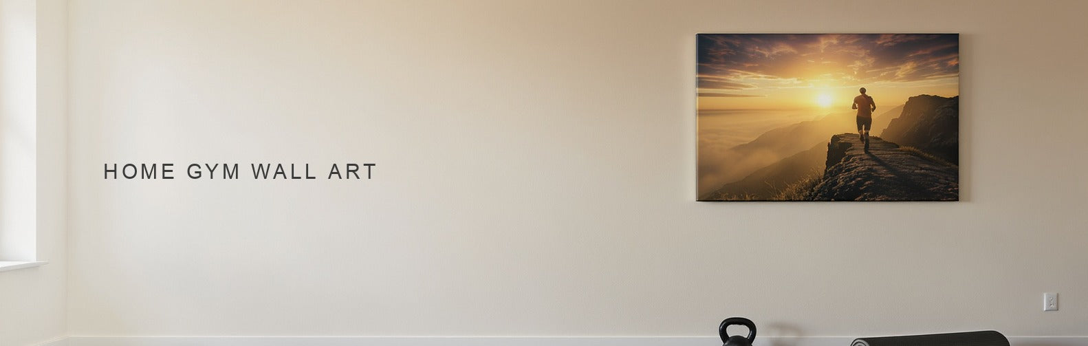 Home gym wall art: a high contrast mountain ridge canvas above a kettlebell and rolled mat
