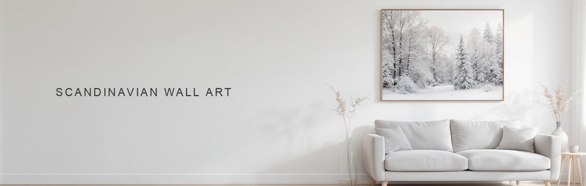 Scandinavian wall art: a pale snowy forest canvas above a light grey sofa on white oak floor