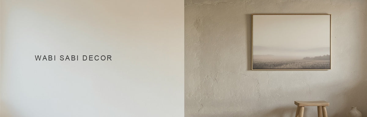 Wabi sabi decor: a muted misty field canvas above a rough plaster wall and an irregular ceramic pot