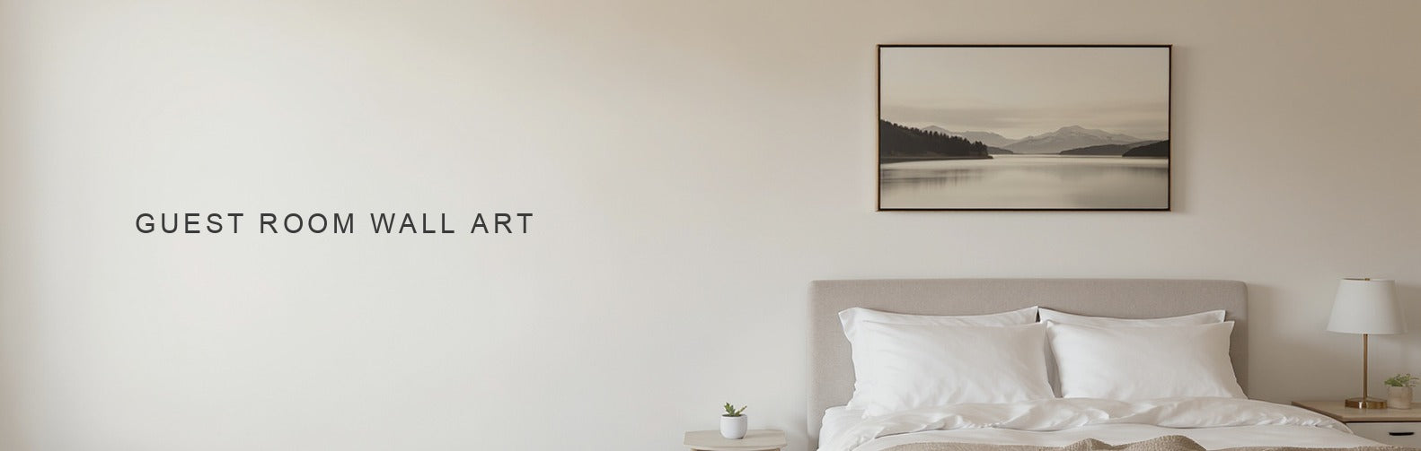 Guest room wall art: a wide muted landscape canvas centred above a made guest bed