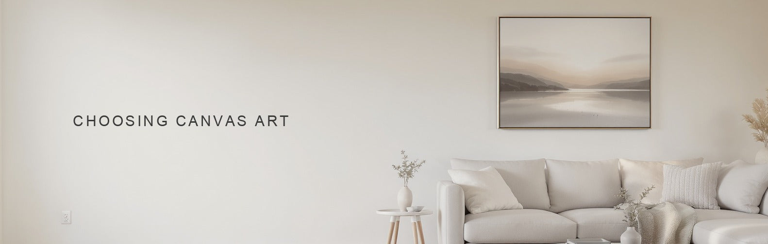 Choosing canvas art: a soft abstract landscape canvas centred above a pale sofa, wrapped edge visible