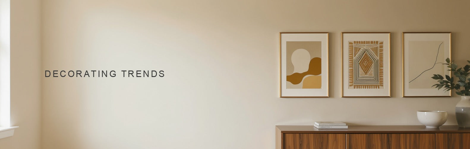 How decorating trends change: three canvas prints in different styles hung in a row above a walnut credenza