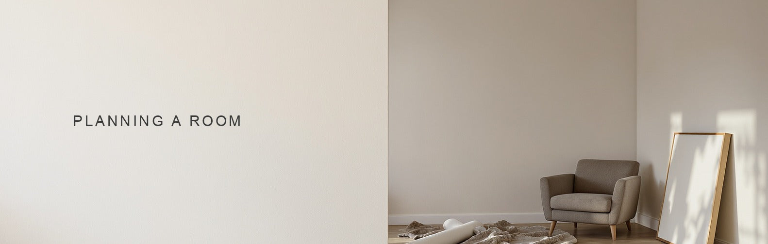 Planning a room from scratch: a canvas print resting on the floor beside a rolled rug and one armchair
