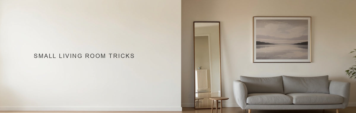 Small living room tricks: a canvas hung high above a slim legged sofa beside a tall narrow mirror