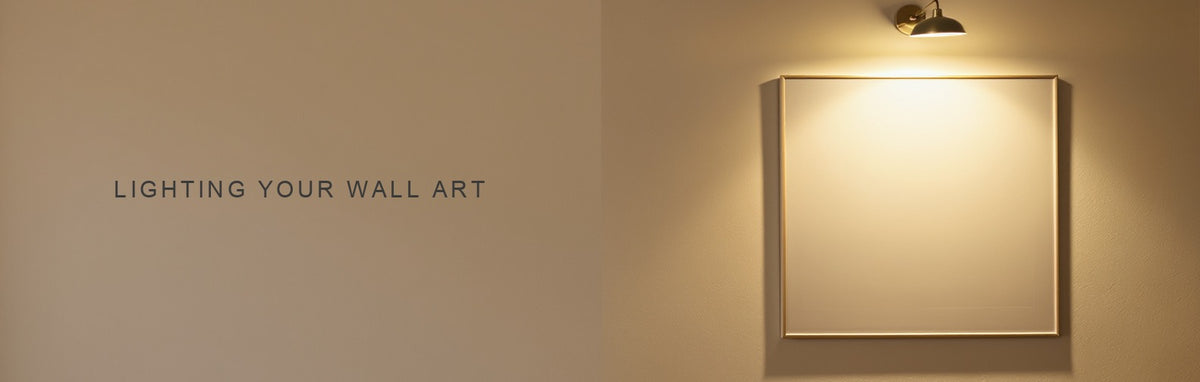 Lighting your wall art: a slim brass picture light casting an even beam across a canvas print