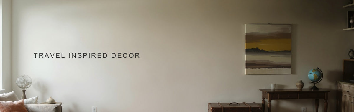 Travel inspired decor: a distant mountain range canvas above a console with a leather suitcase and globe