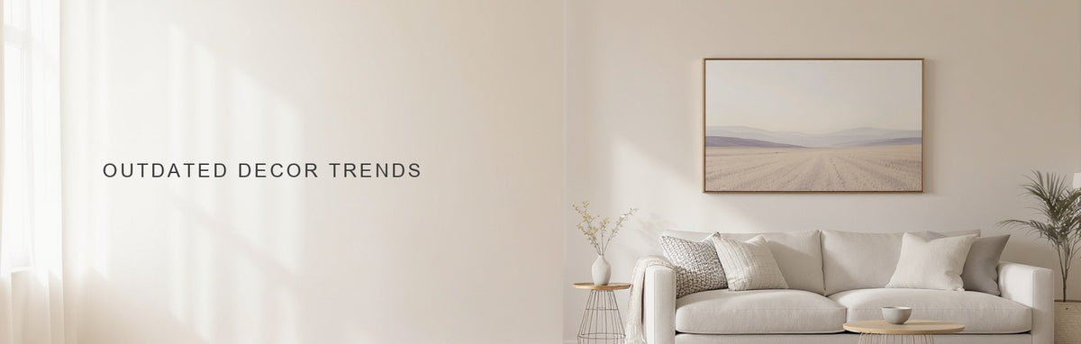 Outdated home decor trends to retire: a restrained living room with one quiet landscape canvas above a linen sofa