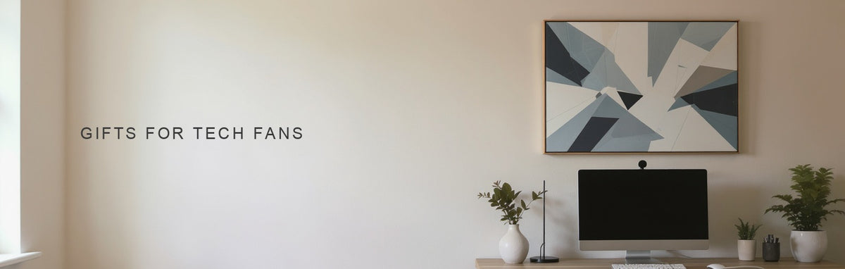 Gifts for tech fans: a cool toned geometric canvas above a modern desk with a mechanical keyboard