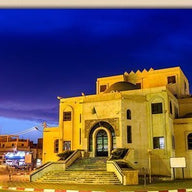 Illuminated Stone Building with Arched Entrance