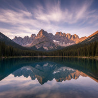 Montana Wall Art canvas print, sharp glacier-carved peaks above a mirror-still alpine lake with pine forest and big open sky