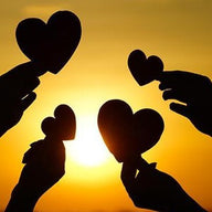 Hands Holding Hearts at Sunset
