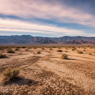 Nevada Wall Art canvas print, a dry cracked desert basin with distant bare ranges under a vast sky