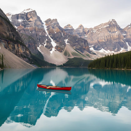 Alberta Wall Art canvas print, a turquoise glacial lake below sheer Rocky Mountain peaks with a canoe on the still water