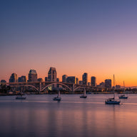 San Diego Wall Art canvas print, the bay and skyline at dusk with the long curved bridge and sailboats in warm light