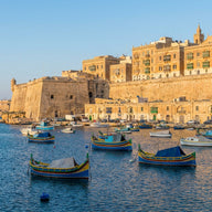 Malta Wall Art canvas print, the honey-colored limestone bastions of Valletta above a harbor of blue water and traditional