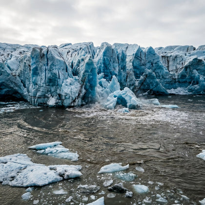 Global Warming Wall Art canvas print, a calving glacier front, blue ice cliffs collapsing into dark meltwater