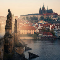 Prague Wall Art canvas print, the statues of the Charles Bridge with the castle and cathedral above red rooftops in dawn mist