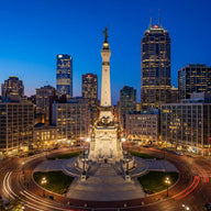 Indianapolis Wall Art canvas print, the limestone monument on its circle with the skyline behind at blue hour