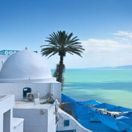 Mediterranean wall art canvas print of whitewashed Santorini houses above the blue sea