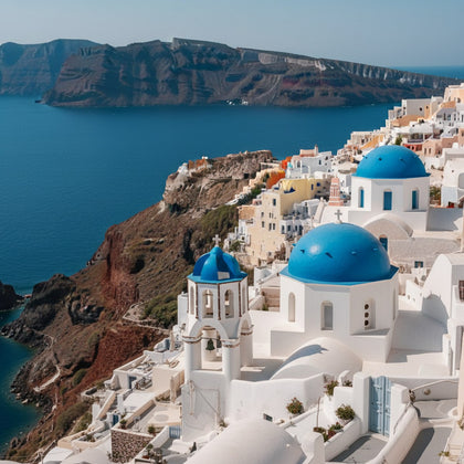Santorini Wall Art canvas print, whitewashed cave houses and blue church domes stepping down the caldera cliff above