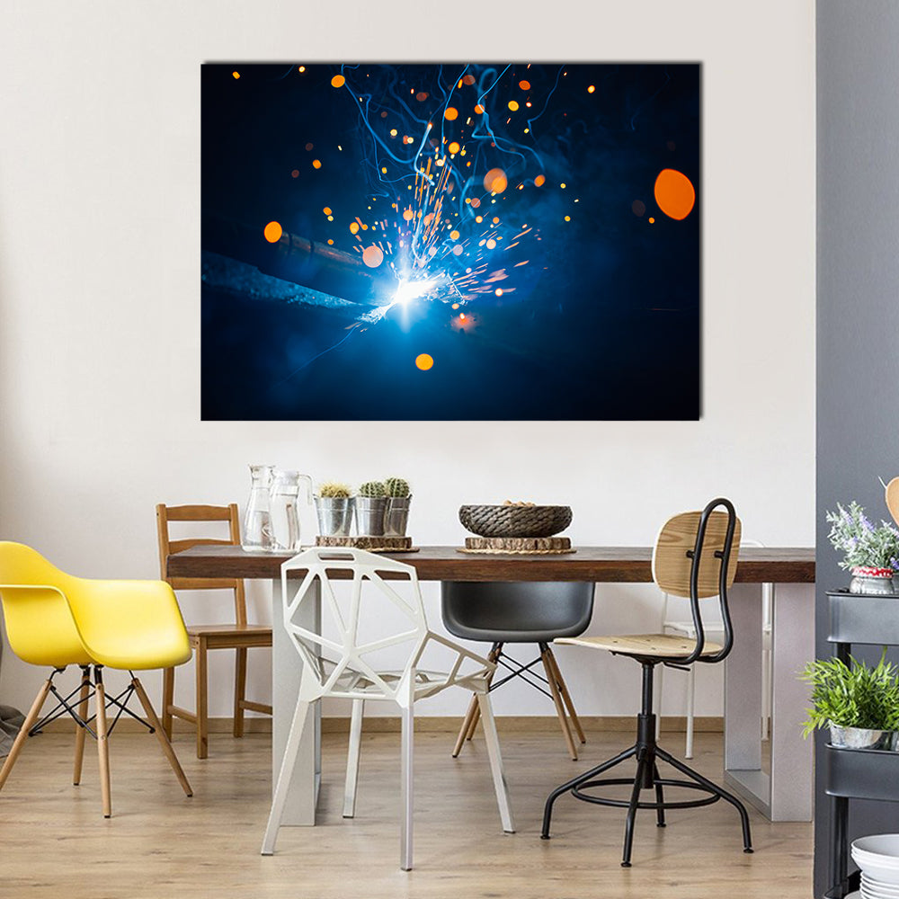 Welding Arc with Blue Smoke and Sparks Canvas Wall Art in black, orange and blue, single panel hung on a wall
