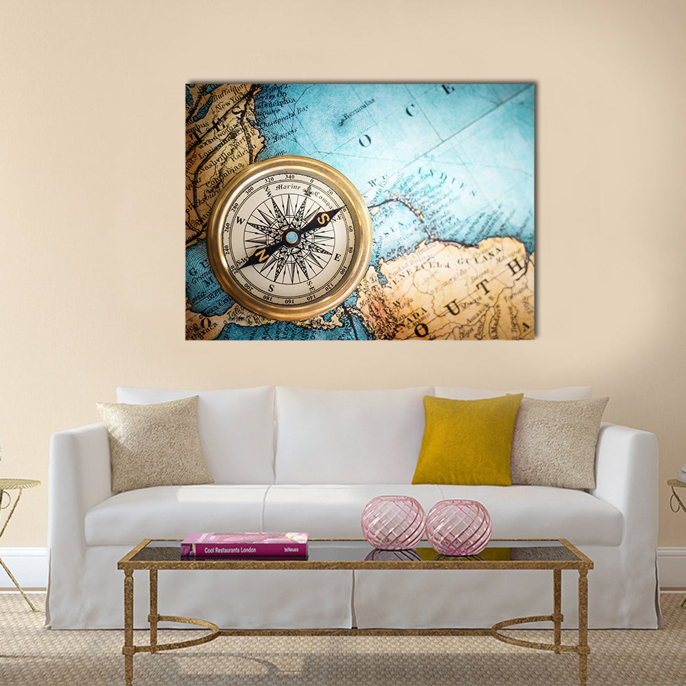 Brass Compass on Antique World Map Canvas Wall Art in brown, gold and blue, single panel hung on a wall