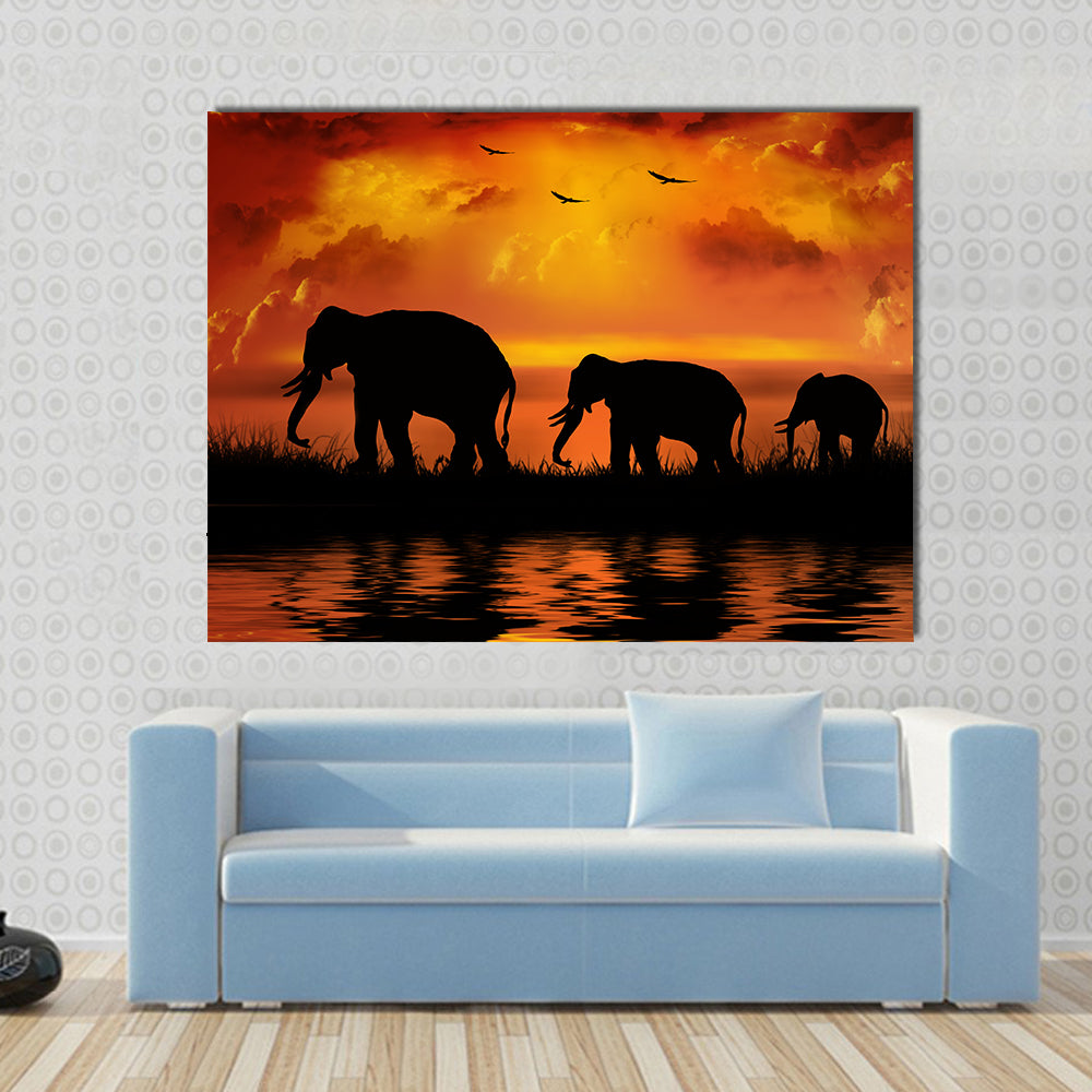 Three Elephants at Sunset Canvas Wall Art in black, orange and yellow, single panel hung on a wall