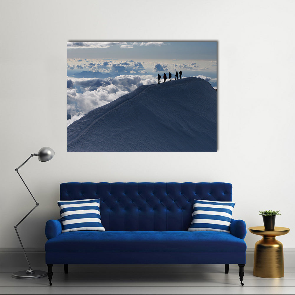 Climbers On Mountain Top Canvas Wall Art in white, gray and blue, single panel hung on a wall