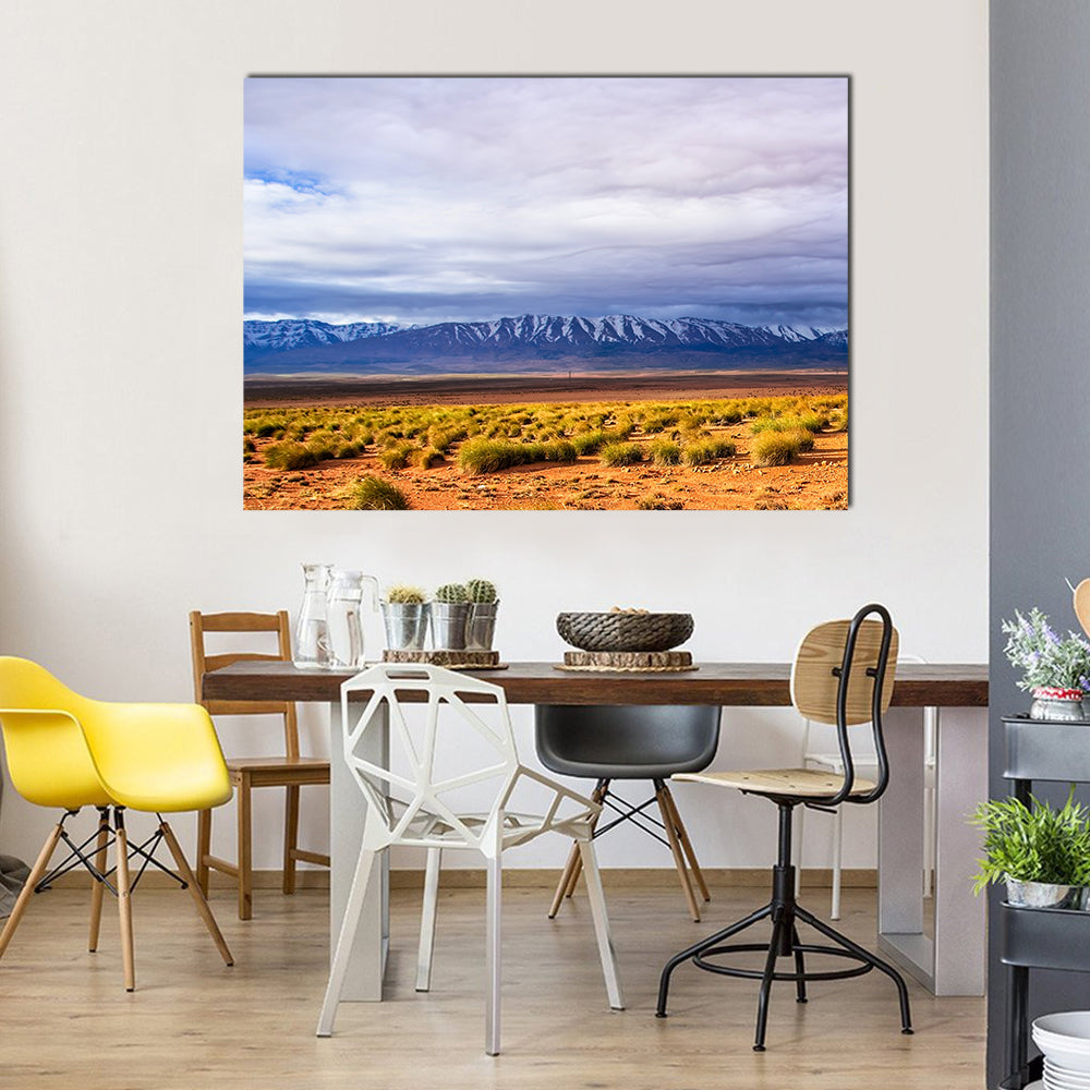 Morocco Desert with Snow-capped Peaks Canvas Wall Art in brown, orange and blue, single panel hung on a wall