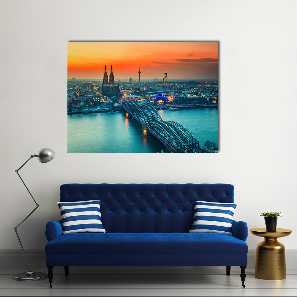 Cologne Cathedral And Hohenzollern Bridge At Night In Germany Canvas Wall Art in gray, orange and yellow, single panel hung on a wall