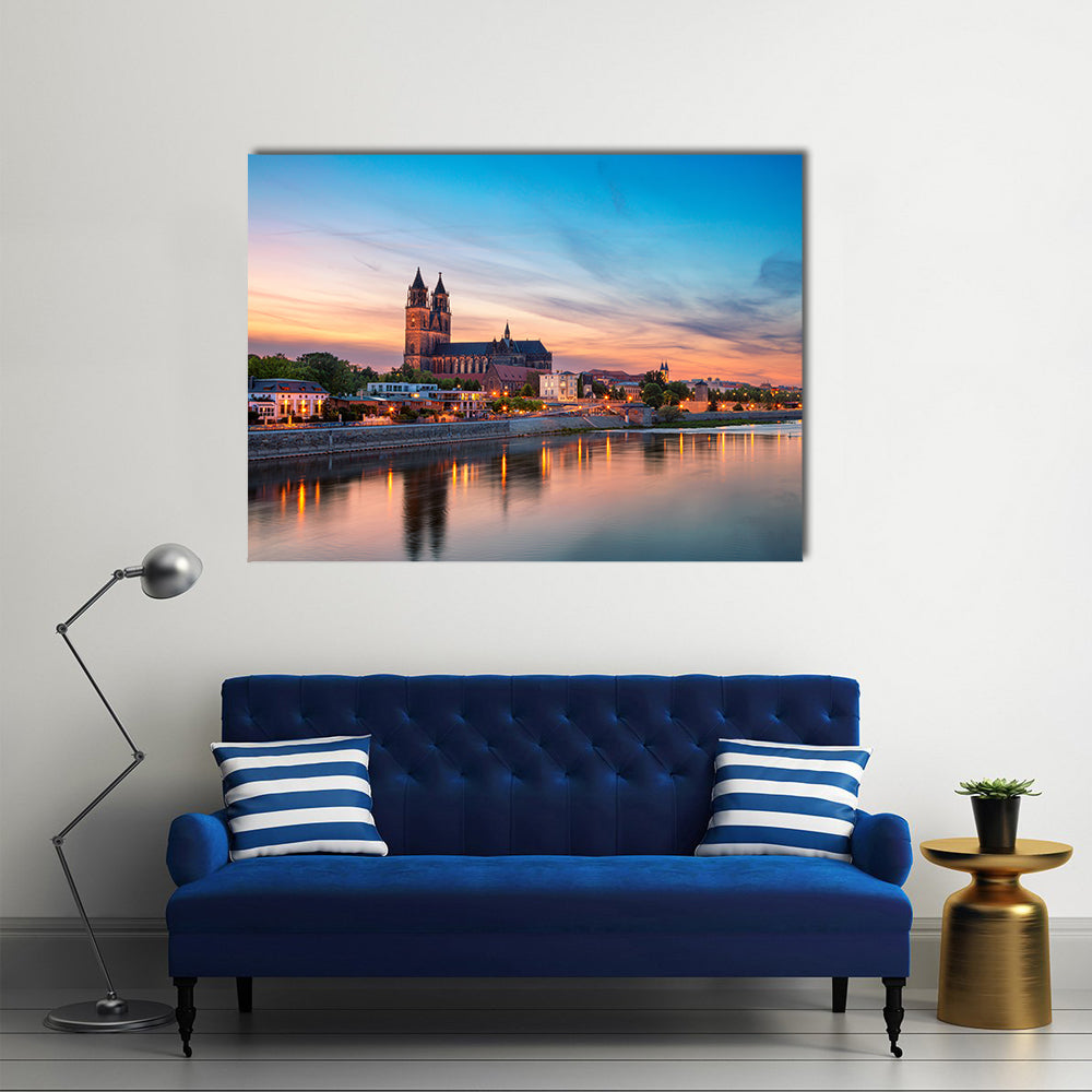 Magdeburg City And Elbe River At Sunset In Germany Canvas Wall Art in orange, yellow and blue, single panel hung on a wall