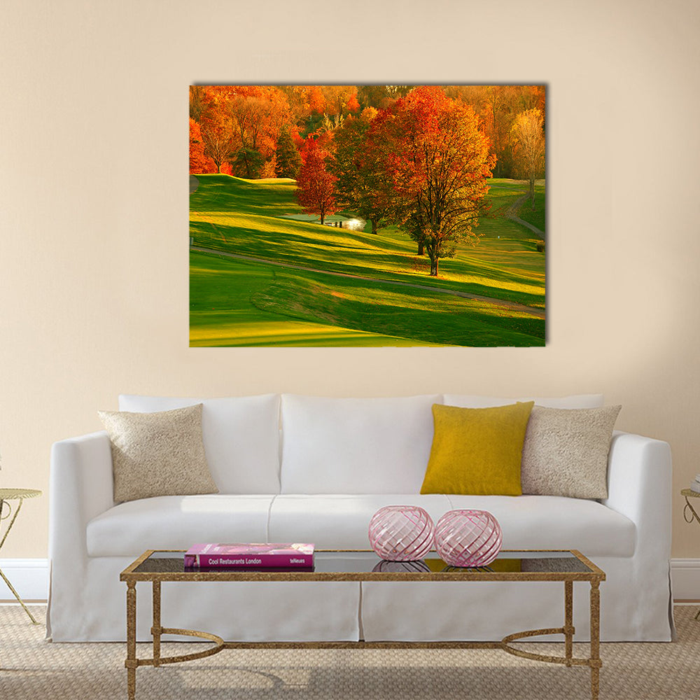Sunset At The Golf Course Canvas Wall Art in orange, yellow and green, single panel hung on a wall