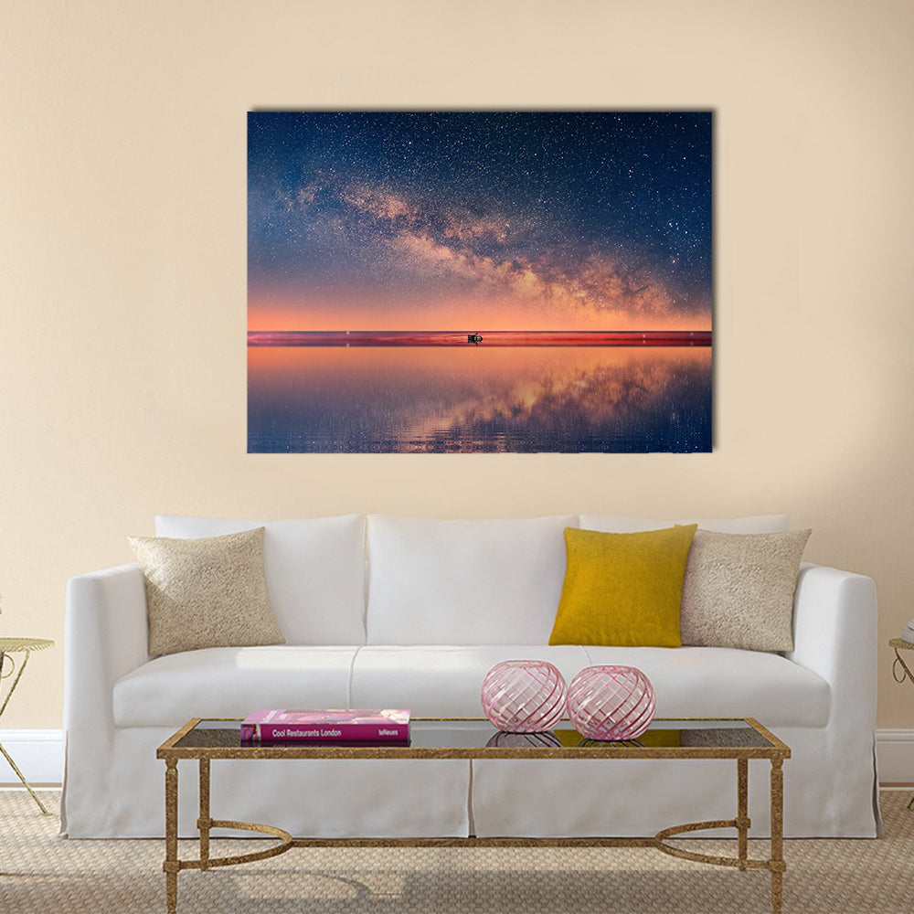 Starry Night Universe At Sea Canvas Wall Art in orange, blue and navy, single panel hung on a wall