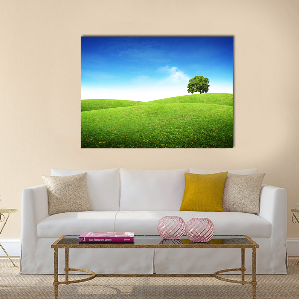 Lone Tree on Rolling Green Hills Canvas Wall Art in green and blue, single panel hung on a wall