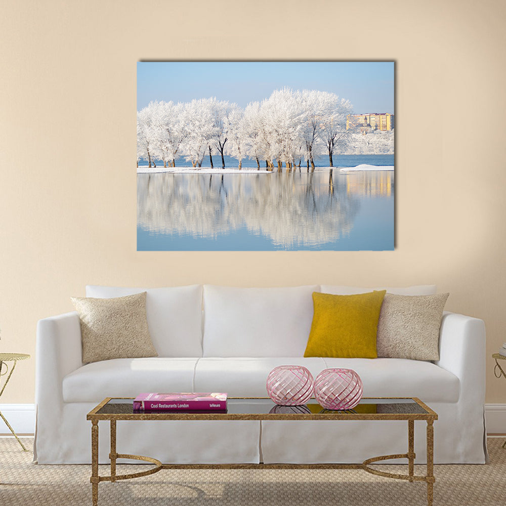 Winter Landscape by the River Canvas Wall Art in white and blue, single panel hung on a wall