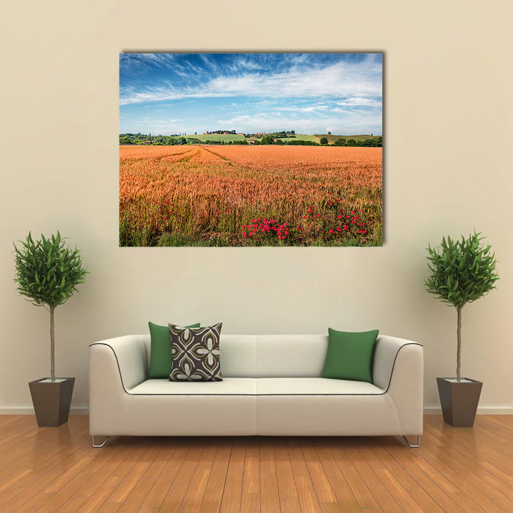 Wheat Field In Tuscany Canvas Wall Art in gold, orange and blue, single panel hung on a wall