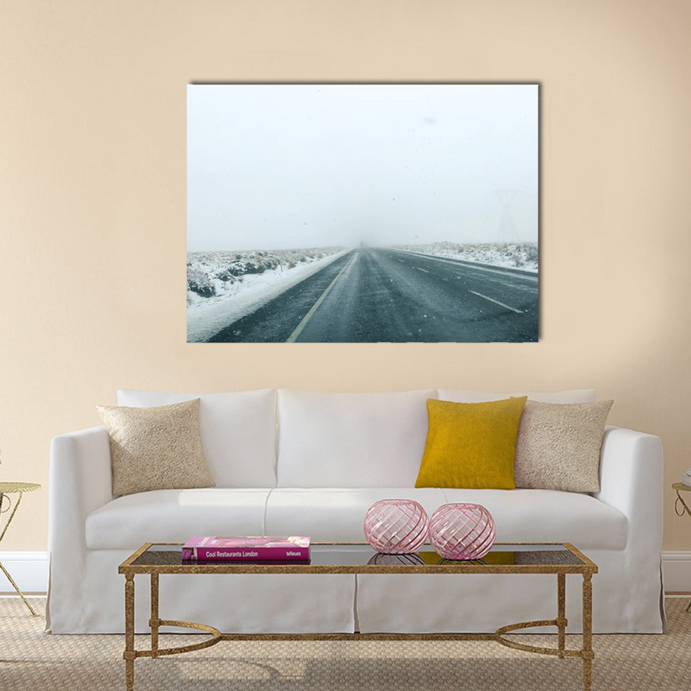 Mountain Road in Winter Storm Canvas Wall Art in black, white and gray, single panel hung on a wall