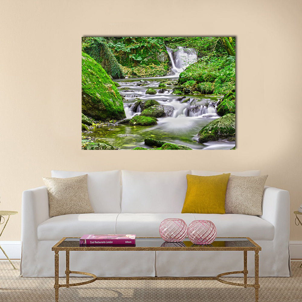Tranquil Forest Stream And Waterfall Canvas Wall Art in white, gray and green, single panel hung on a wall