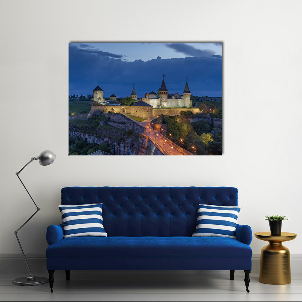 Kamianets Podilskyi Castle At Dusk In Ukraine Canvas Wall Art in gray, yellow and blue, single panel hung on a wall