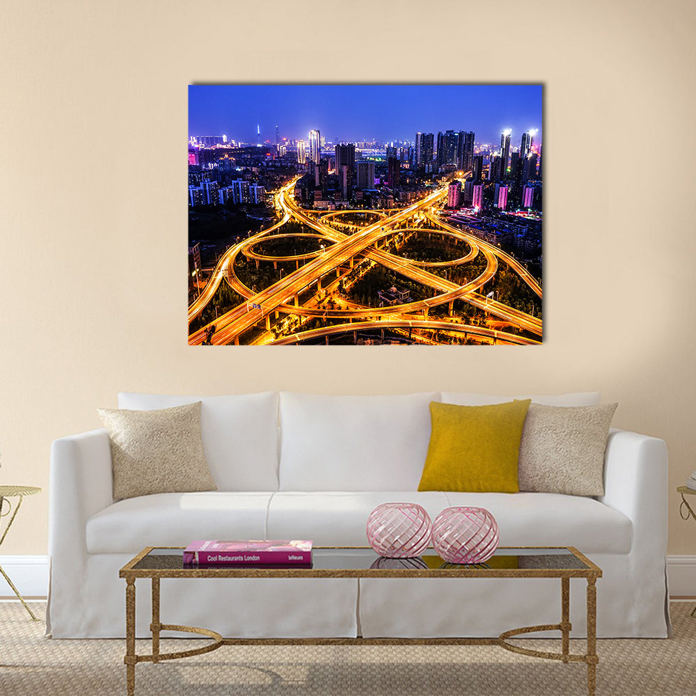 Night Traffic Interchange in Hanyang, Wuhan Canvas Wall Art in orange, yellow and blue, single panel hung on a wall
