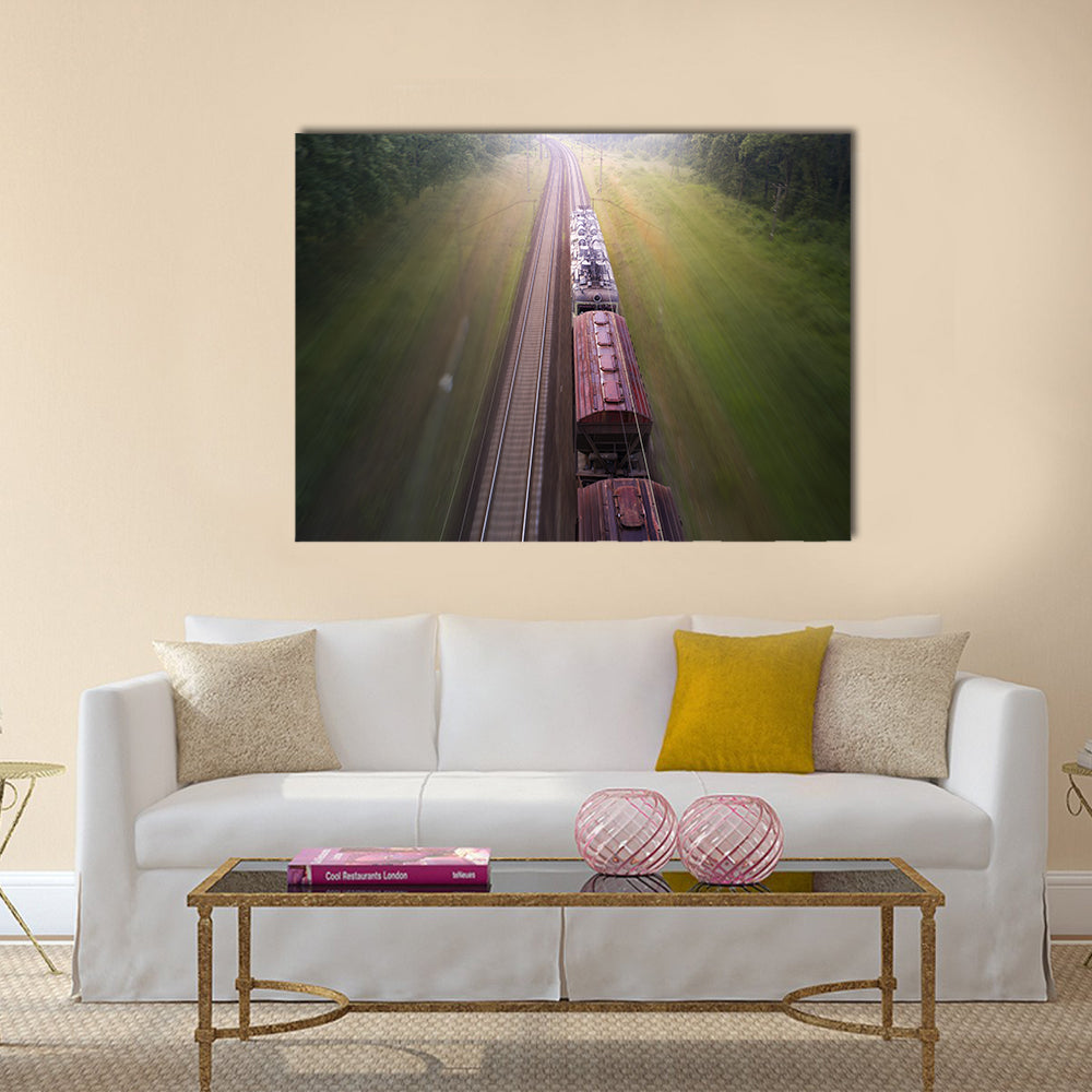 Freight Train Travels Through Foggy Forest Canvas Wall Art in gray, brown and green, single panel hung on a wall