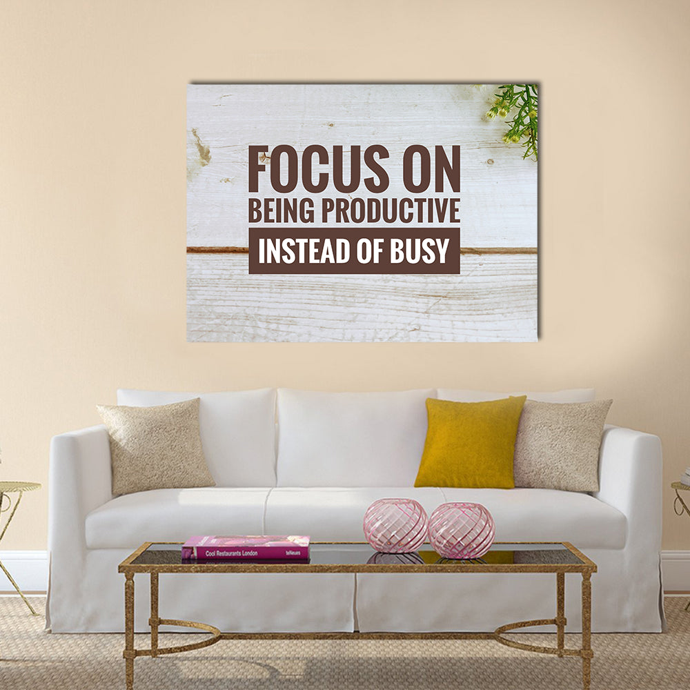 Focus on Being Productive Quote on Wood Canvas Wall Art in white and brown, single panel hung on a wall