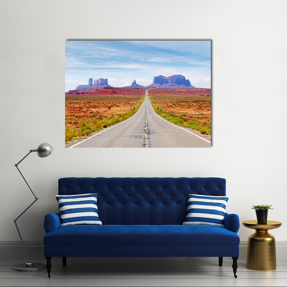U.s. Route 163 Through Monument Valley Canvas Wall Art in gray, orange and blue, single panel hung on a wall