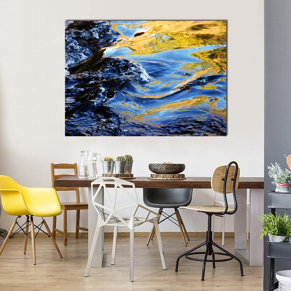 Autumn Trees Over Mountain Stream Canvas Wall Art in gold, yellow and blue, single panel hung on a wall