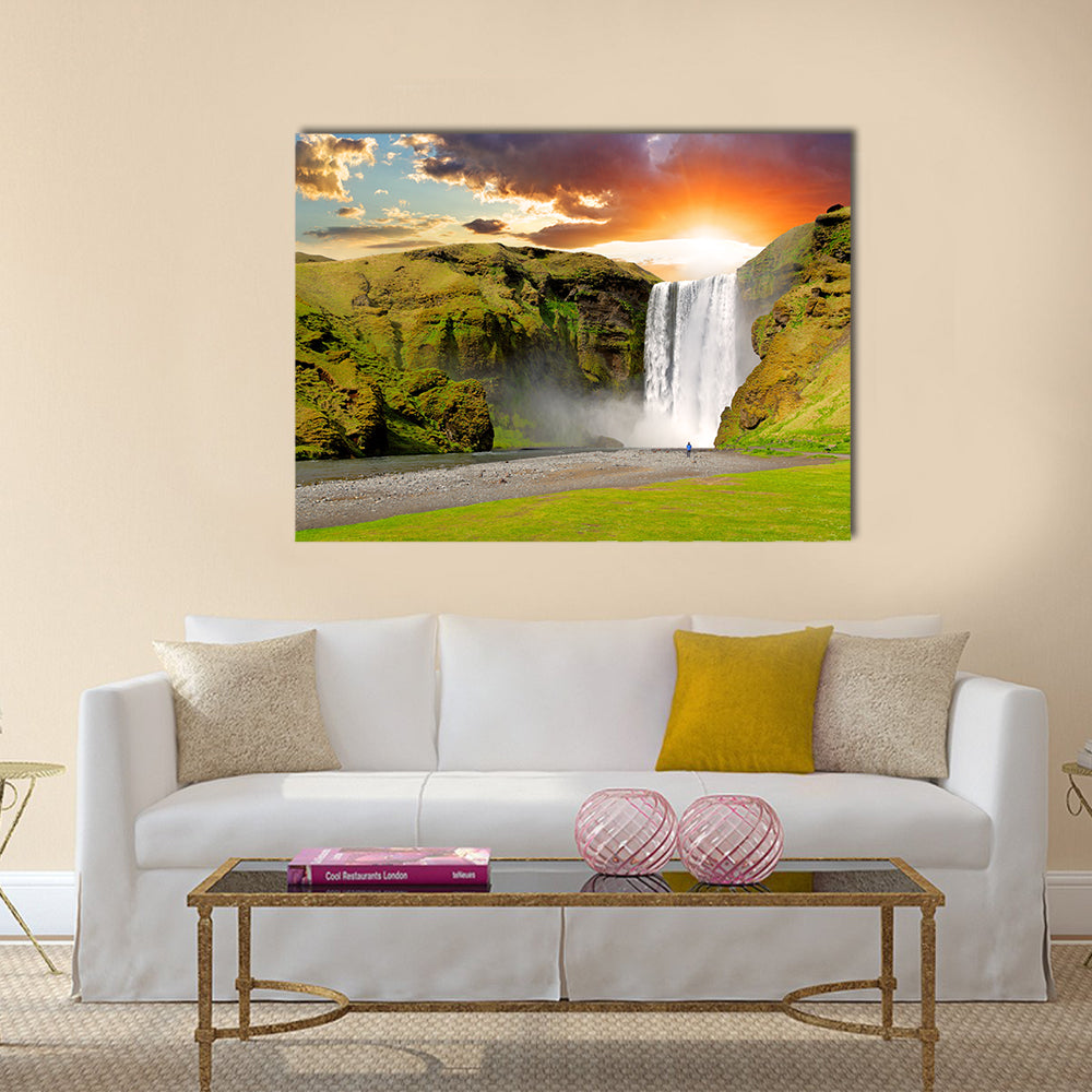 Skogafoss Waterfall At Sunset In Iceland Canvas Wall Art in orange, yellow and green, single panel hung on a wall