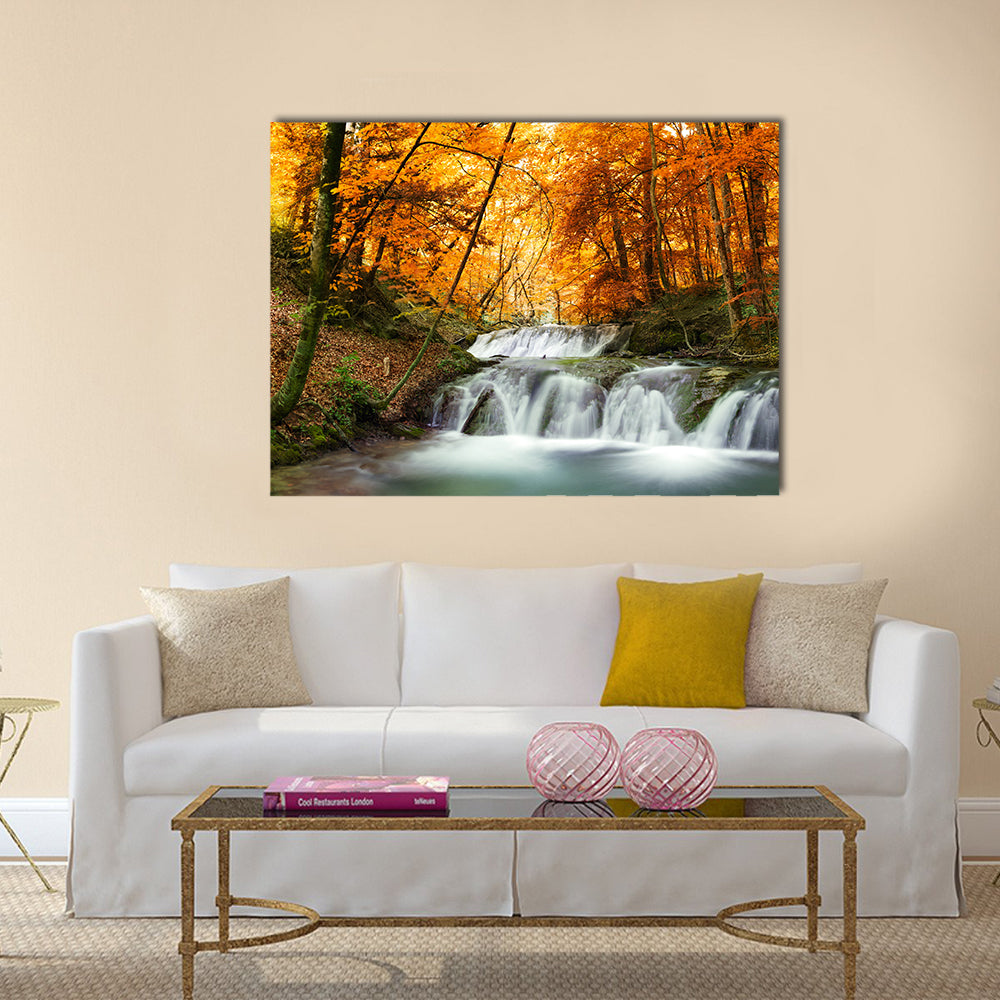 Waterfall In Autumn Forest Thailand Canvas Wall Art in brown, orange and yellow, single panel hung on a wall